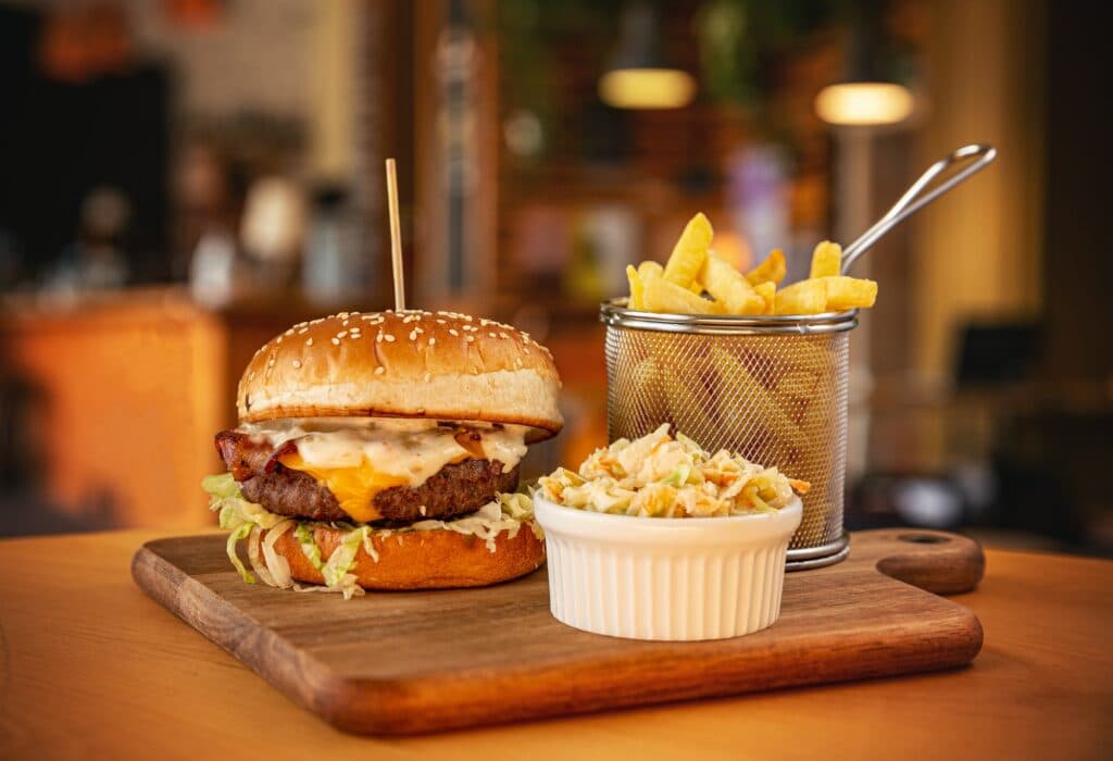 Tasty burger with fries